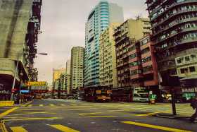 This bus and tram are dwarfed by typical Hong Kong high rises