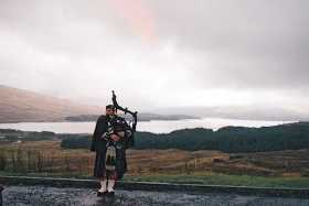 A lone Highland piper greets us on a bleak day at Rannoch Moor