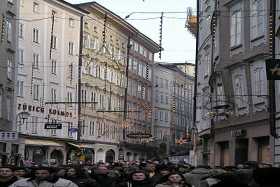 The narrow streets of the old town of Salzburg throng with Christmas tourists