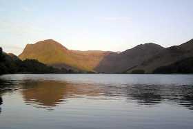 The last of day's sun shines on Fleetwith Pike and Haystacks in Buttermere