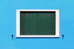 The bright colours on Burano's walls in stark contrast to the dark window shutters