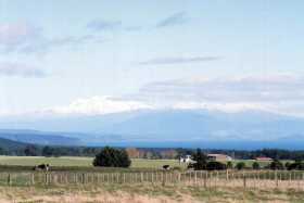 The volcanos of Tongariro National Park loom over Lake Taupo