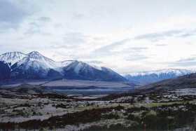 The setting sun shows off the Southern Alps in a warm light